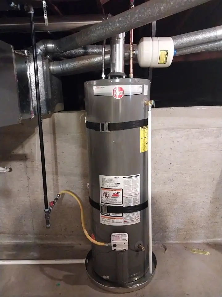 New gas tank water heater with expansion tank in a basement